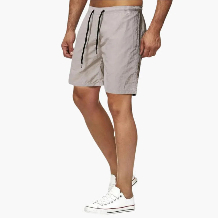 Versatile men's quick-dry swim shorts, ideal for beach, poolside, or active summer adventures. Drawstring.
