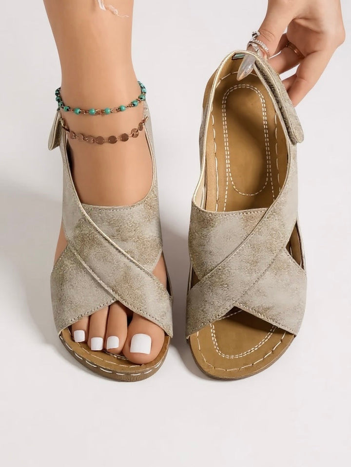Elegant women's platform wedge sandals with chic cross straps, ideal for summer occasions.
