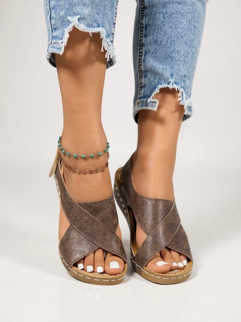 Stylish women's cross strap wedge sandals, featuring a comfortable platform heel.