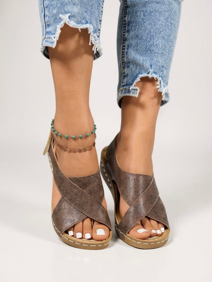 Stylish women's cross strap wedge sandals, featuring a comfortable platform heel.