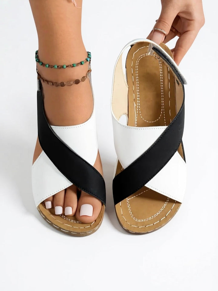 Comfortable women's wedge sandals: chic cross strap design on a supportive platform sole.