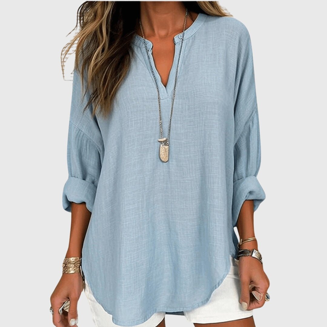 Women's graceful V-neck tunic shirt with relaxed long sleeves, perfect for casual or beach wear.