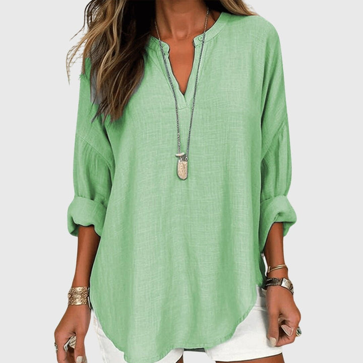 Stylish women's V-neck tunic shirt, featuring relaxed long sleeves & a graceful, comfortable fit.