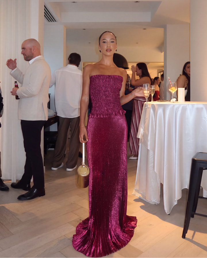 Women's berry strapless sequin maxi dress. Elegant evening gown with a pleated skirt, perfect for formal events.