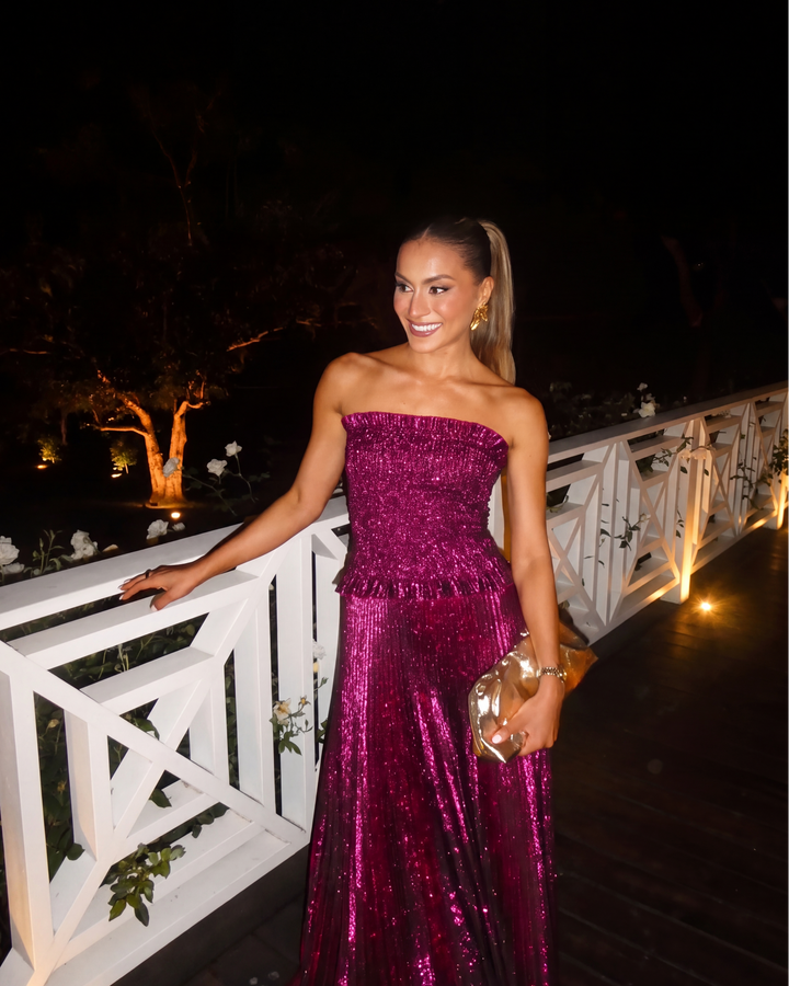 Front view of a women's strapless berry sequin maxi dress. Elegant formal party gown with a flowy pleated skirt.