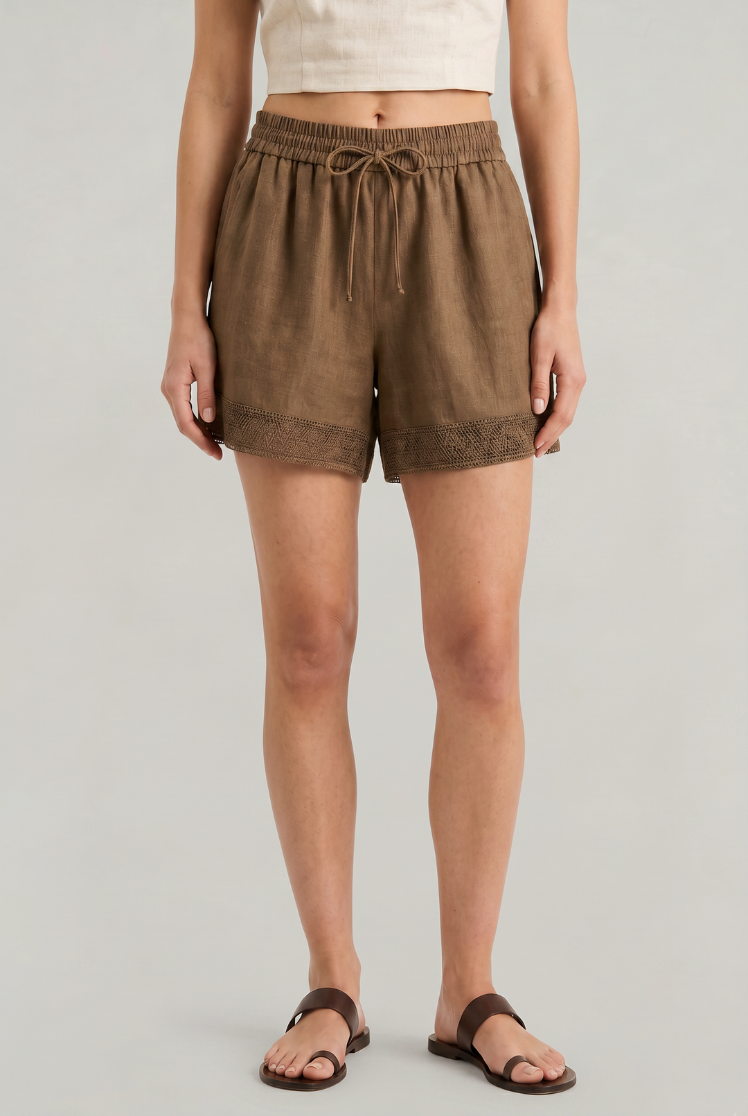 Women's effortless linen drawstring shorts with delicate crochet trim. Perfect for summer casual wear.