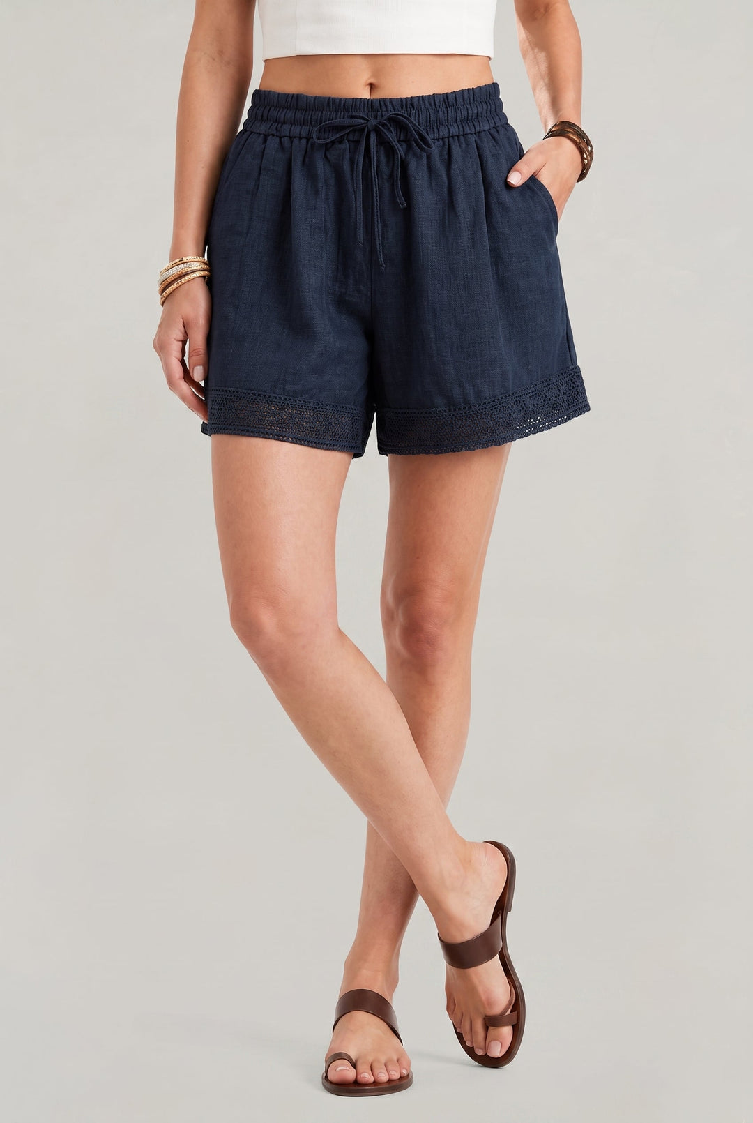 Relaxed fit women's linen shorts with an adjustable drawstring waist and decorative crochet edge. A summer essential.