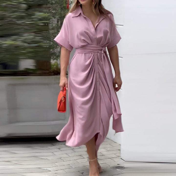 Modern women's belted midi dress with a sleek collar and eye-catching abstract print, perfect for summer events.