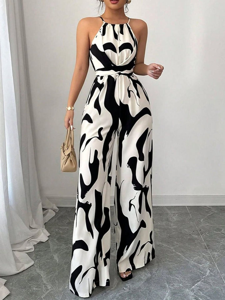 Comfortable women's abstract print wide-leg jumpsuit. Elegant tie-waist one-piece for spring/summer events.