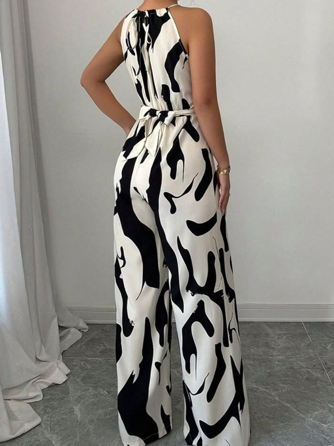 Flowy women's abstract print wide-leg jumpsuit, a comfortable one-piece for effortless summer style & events.