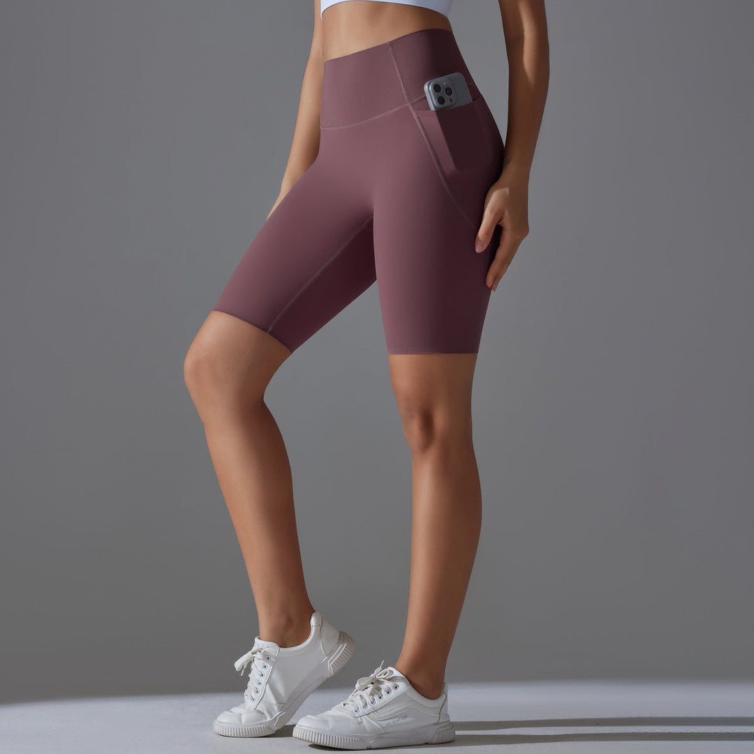 Performance women's fitness shorts, high-waisted design with spacious side pockets.