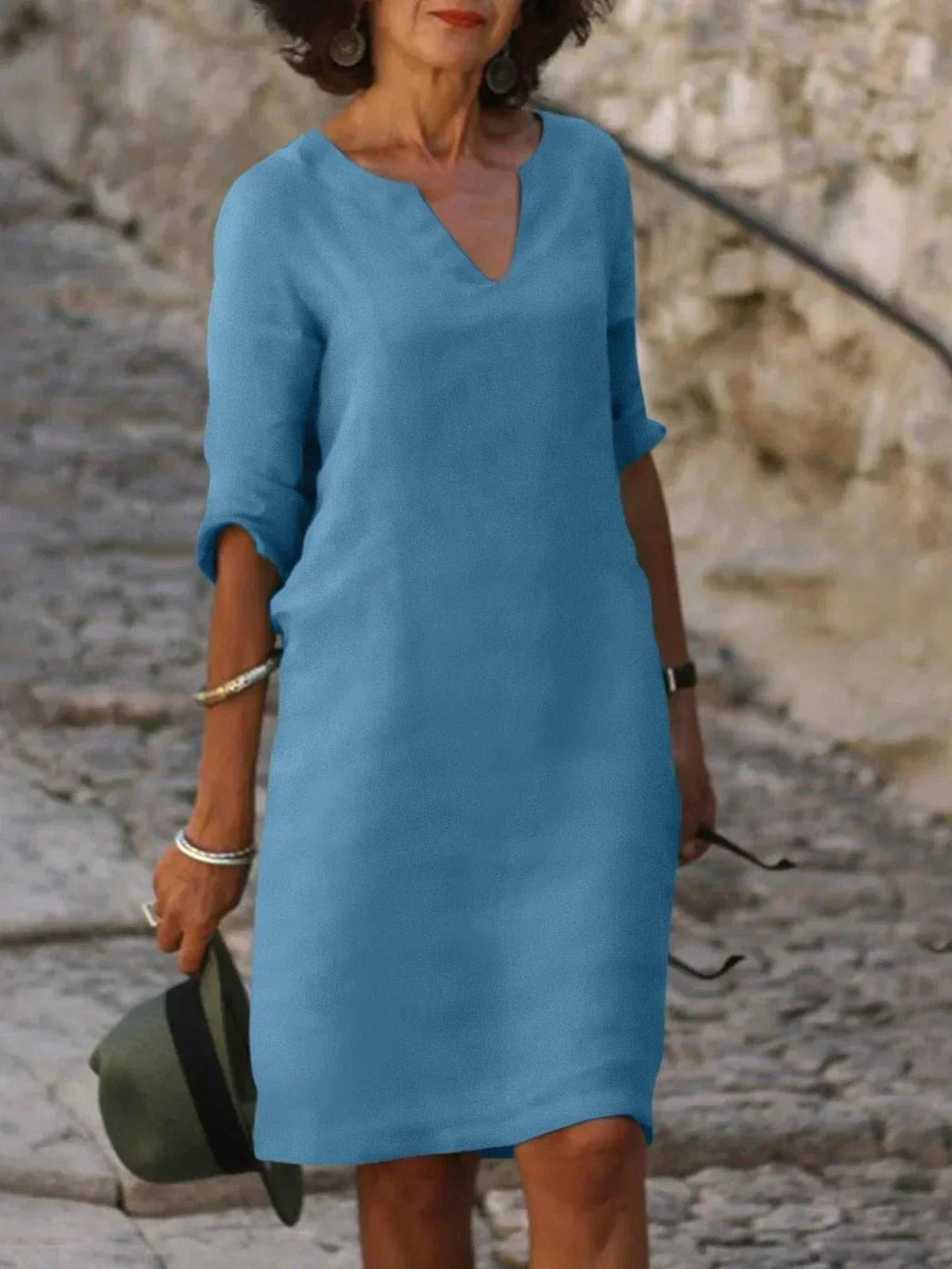 Modern women's V-neck midi dress, flattering summer fashion for elegant party wear.