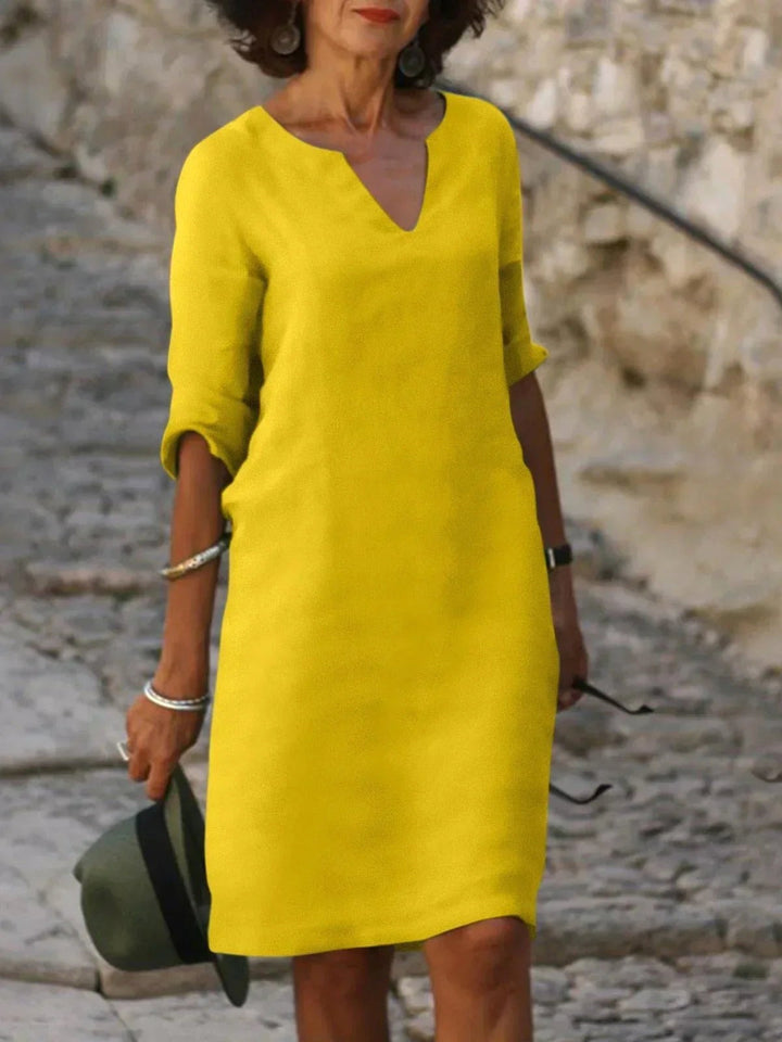 Fashionable women's V-neck midi dress, versatile and chic for summer parties & events.