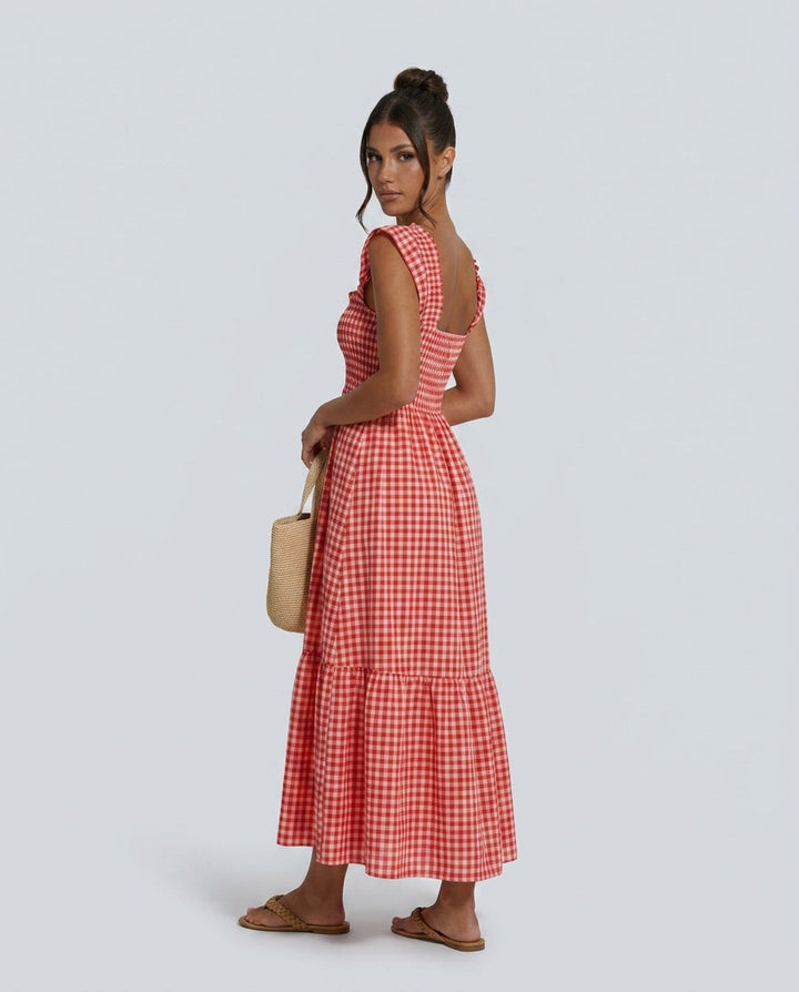 Stylish women's maxi gingham dress with square neck, smocked bodice, and playful ruffle sleeves.