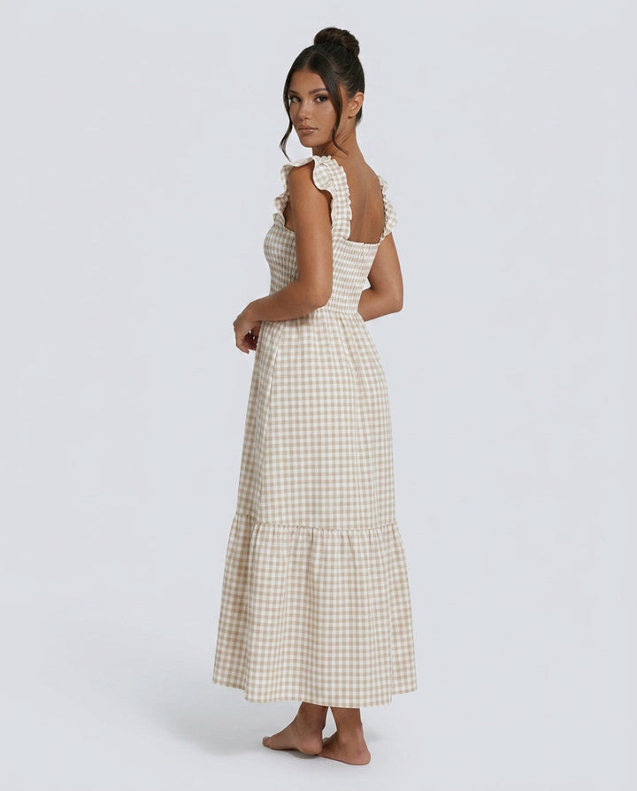 Elegant women's maxi gingham dress featuring a tiered skirt & smocked ruffle sleeves.