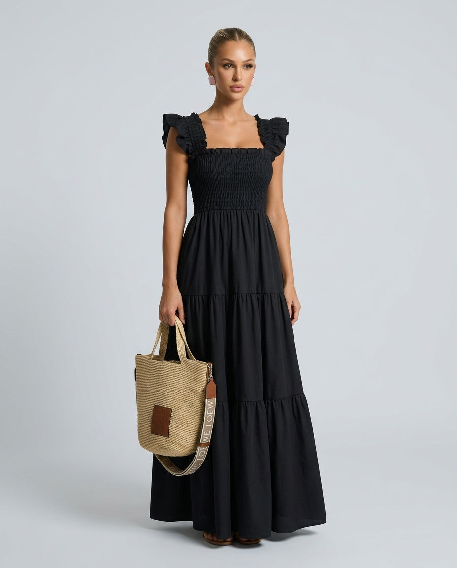 Summer style women's maxi dress: refined gingham print, smocked bodice, and delicate ruffle sleeves.
