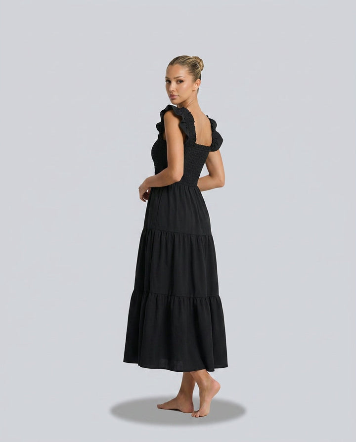 Refined women's elegant maxi gingham dress, complete with smocked detailing & chic ruffle sleeves.