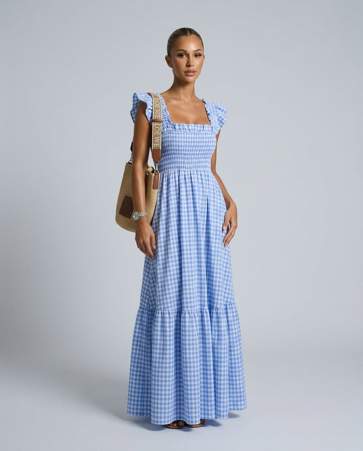 Front view of a women's refined maxi gingham dress with smocked bodice & fashionable ruffle sleeves.