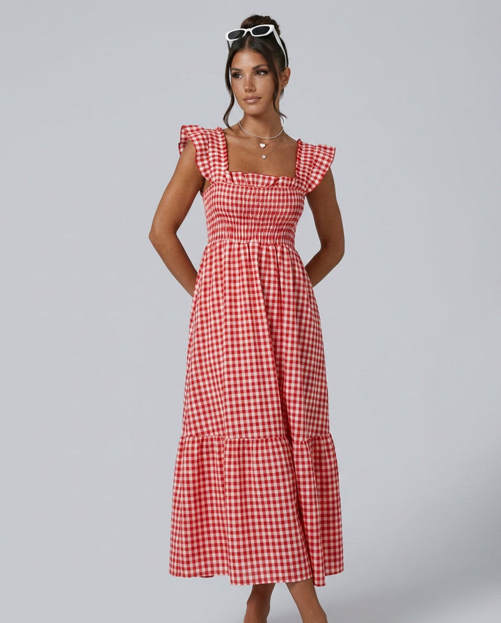 Flowy women's refined maxi gingham dress with elegant smocked ruffle sleeves, ideal for summer wear.