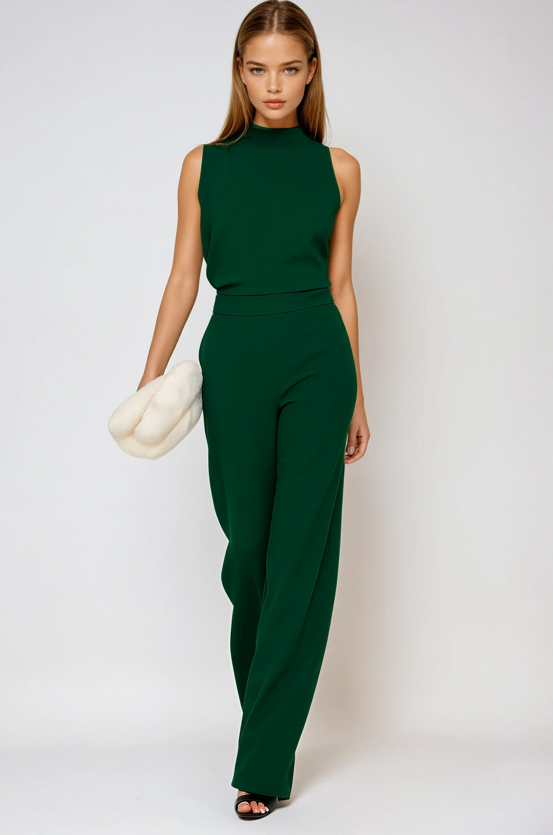 Emerald green sleeveless wide leg jumpsuit with elegant mock neck, perfect for evening wear.