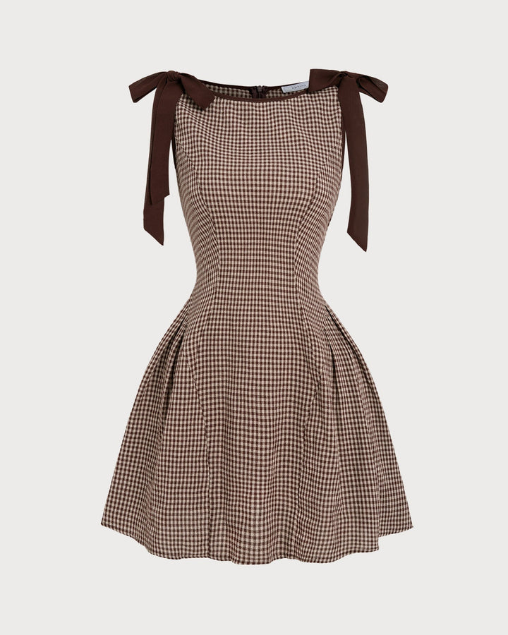 Beautiful women's tie-strap gingham mini dress, embodying sophisticated summer style. Ideal for brunch.