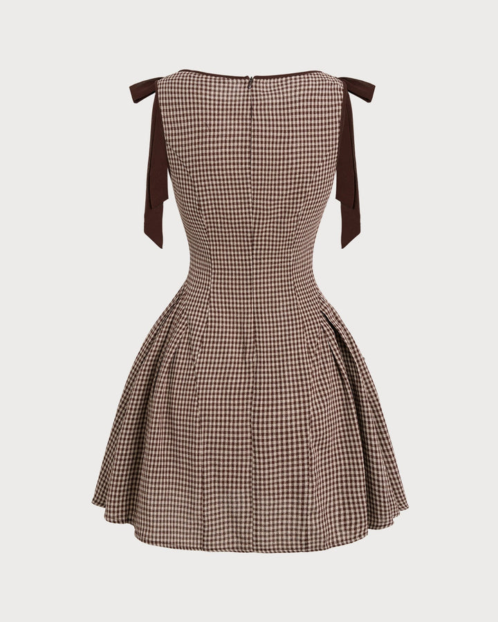 Brown gingham mini dress for women with sophisticated tie straps. Elegant fit and flare brunch dress.