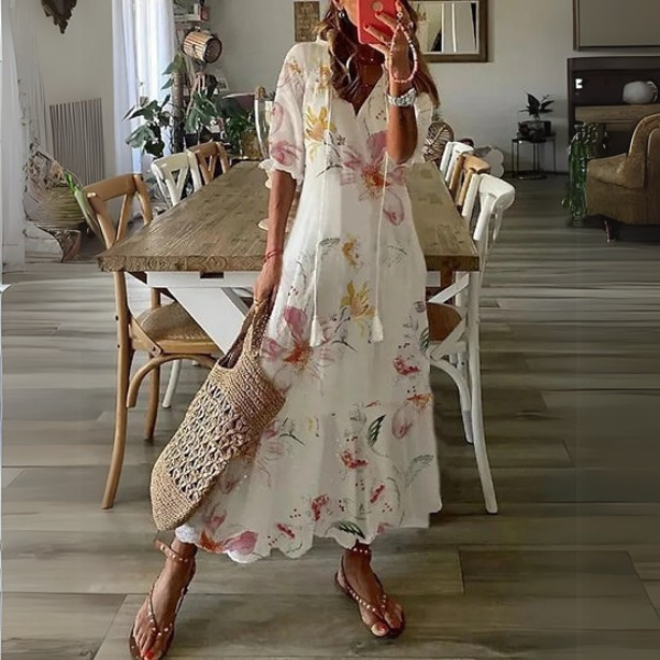Distinctive women's paisley print maxi dress, boho style with tiered skirt, V-neck, and chic tassel ties.