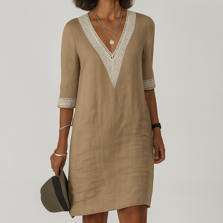 Relaxed fit women's V-neck shift dress with delicate crochet trim for warm weather comfort.