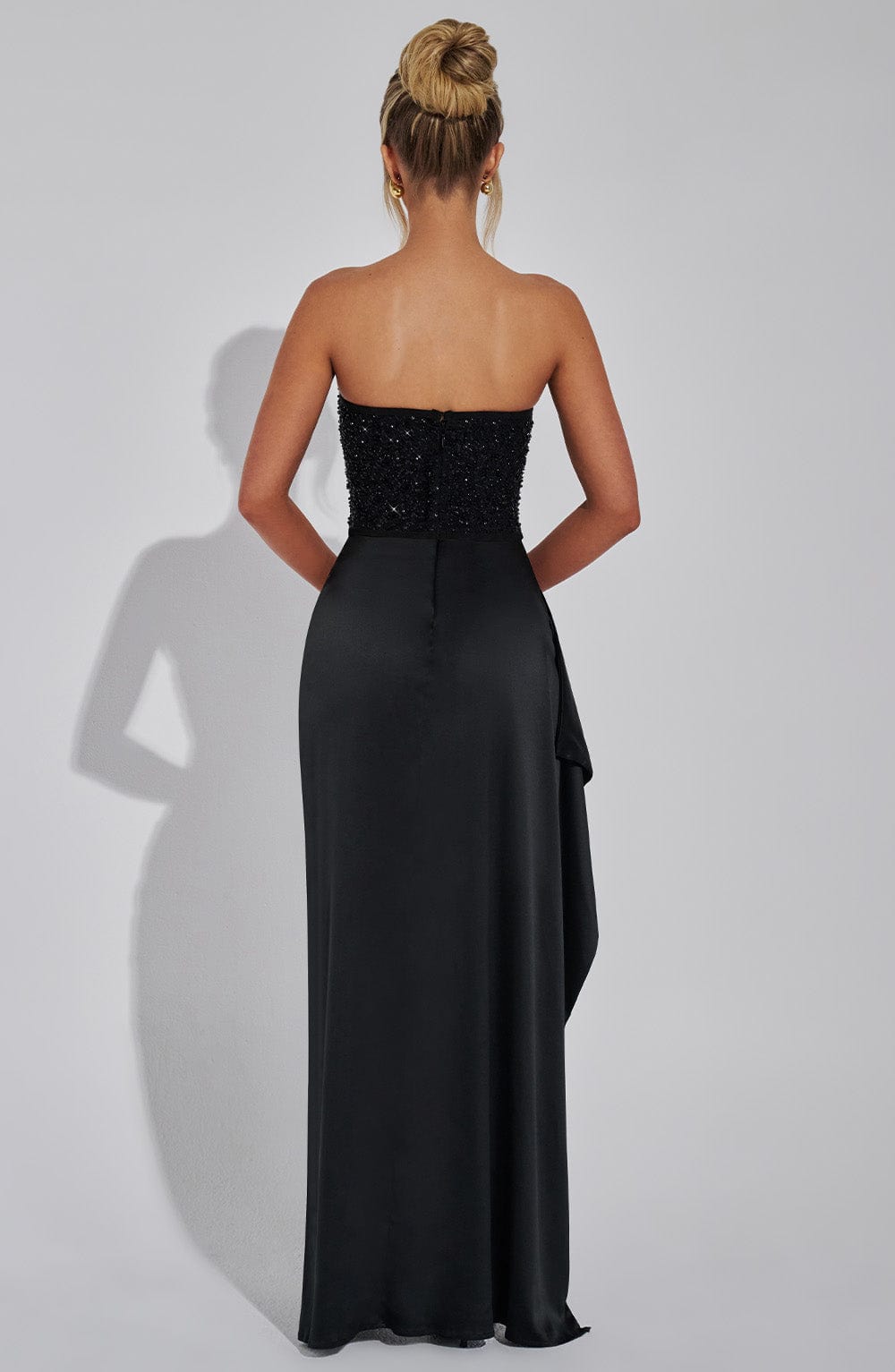 Model wearing the Emrielle beaded corset maxi dress in black and white