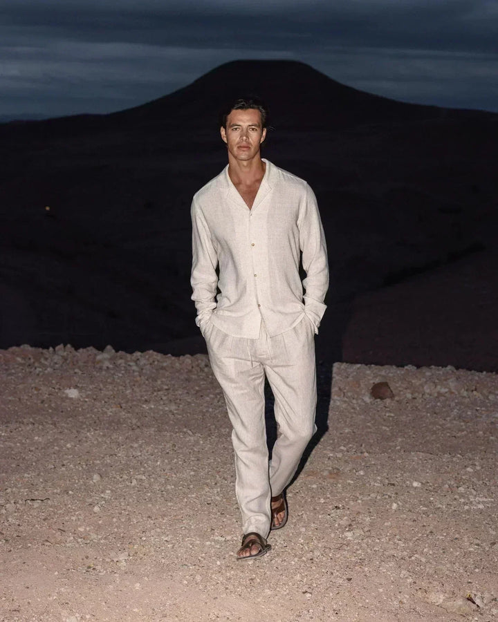 Stylish men's beige Cuban collar long sleeve shirt and casual pants set, perfect for relaxed summer fashion.