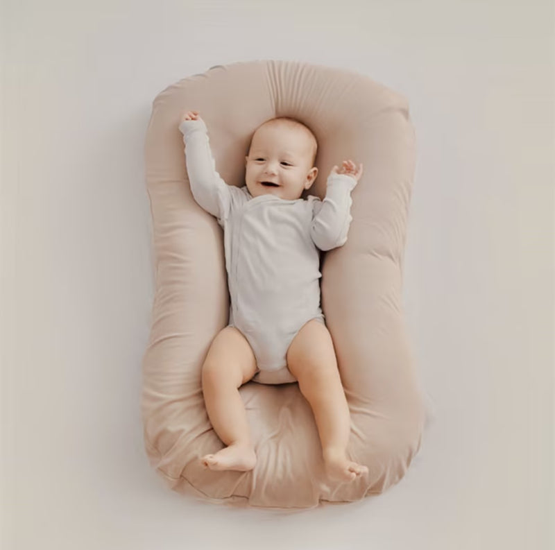 Ergonomic baby pillow for safe infant sleep and head support, preventing flat head syndrome.