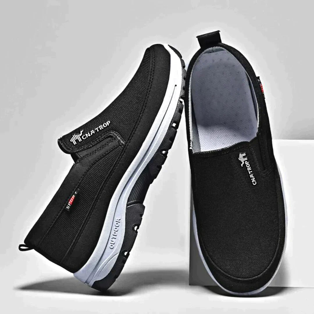 Black men's stylish orthopedic slip-ons, perfect for comfortable walking & general foot wellness.