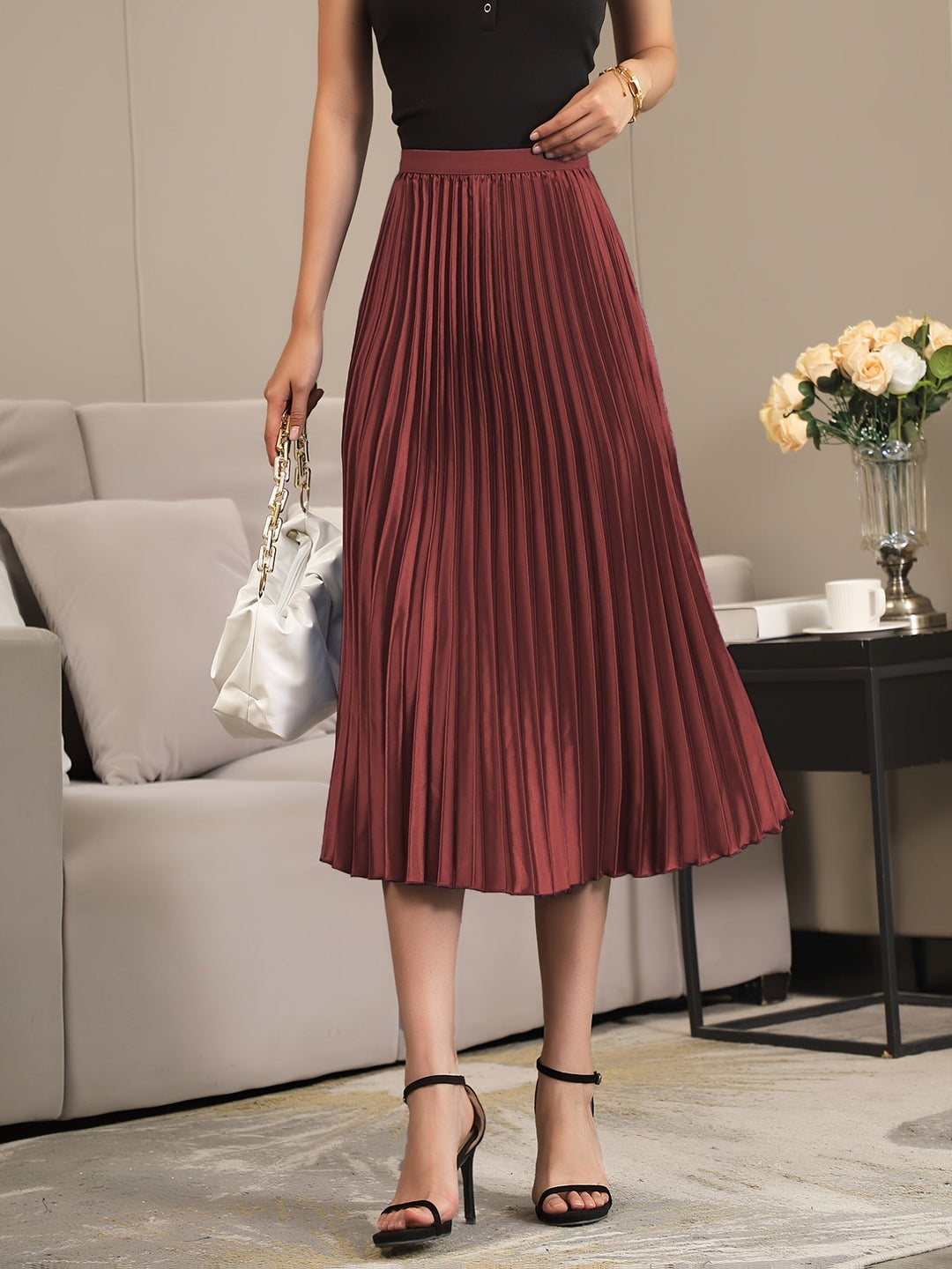 Elegant women's A-line midi skirt, cosy pleats & elastic waist for comfortable, chic style.