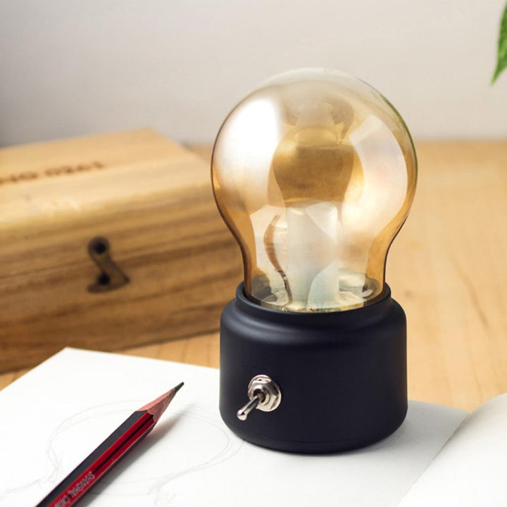 Stylish capsule-design retro LED desk lamp, USB rechargeable with adjustable warm light for reading.