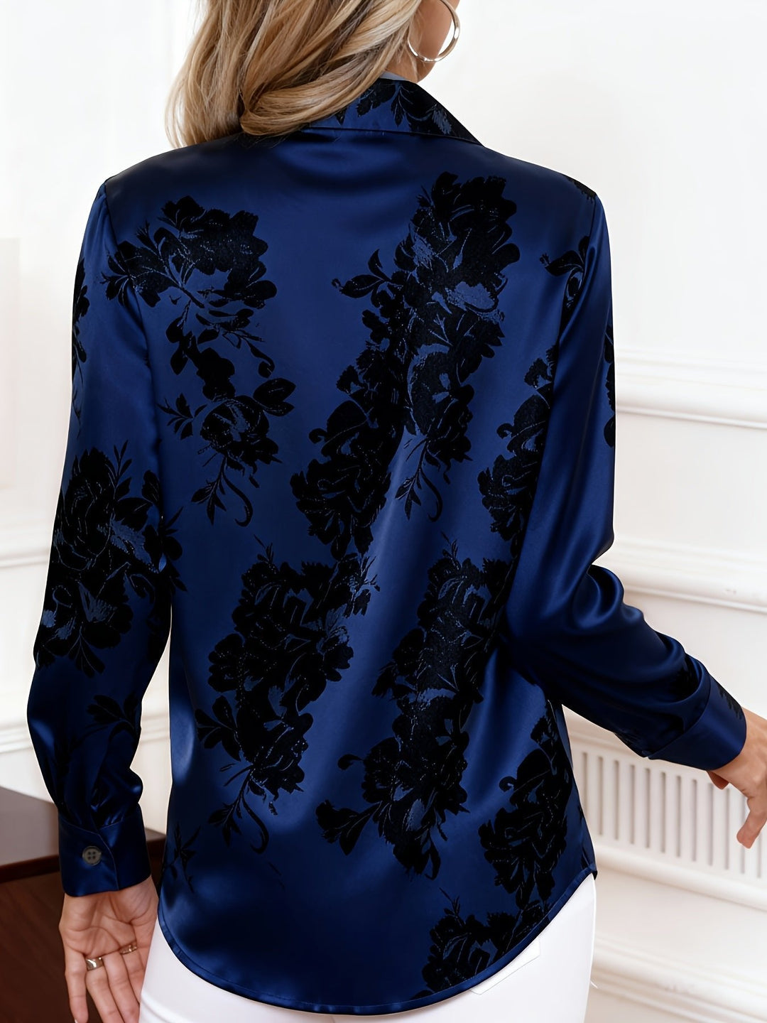 Elegant women's long-sleeve floral print blouse featuring a classic collar and stylish button-front closure.