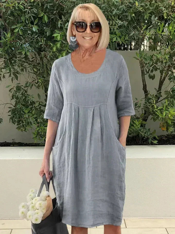 Summer-ready women's loose midi dress, designed for comfort with functional side pockets.