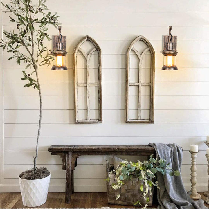 Industrial wall sconce, black finish, offering accent lighting with a vintage feel.