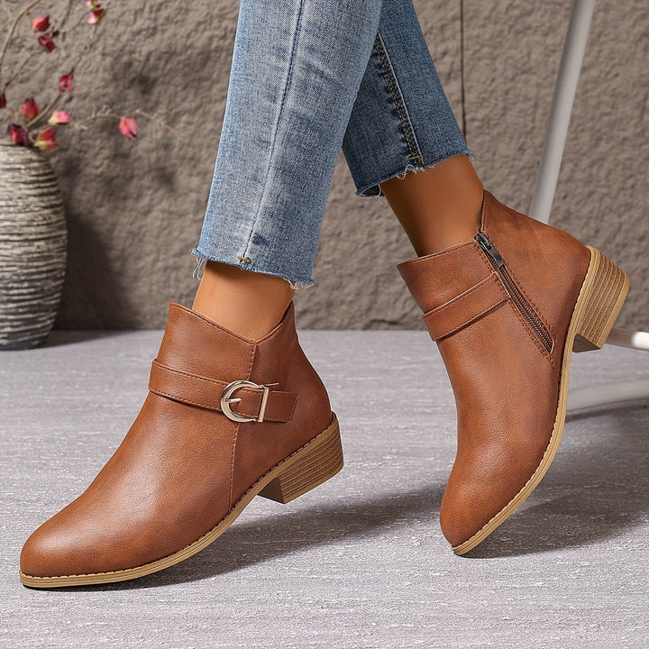 Elegant brown women's Chelsea ankle boots with a modern buckle, round toe, and versatile block heel.