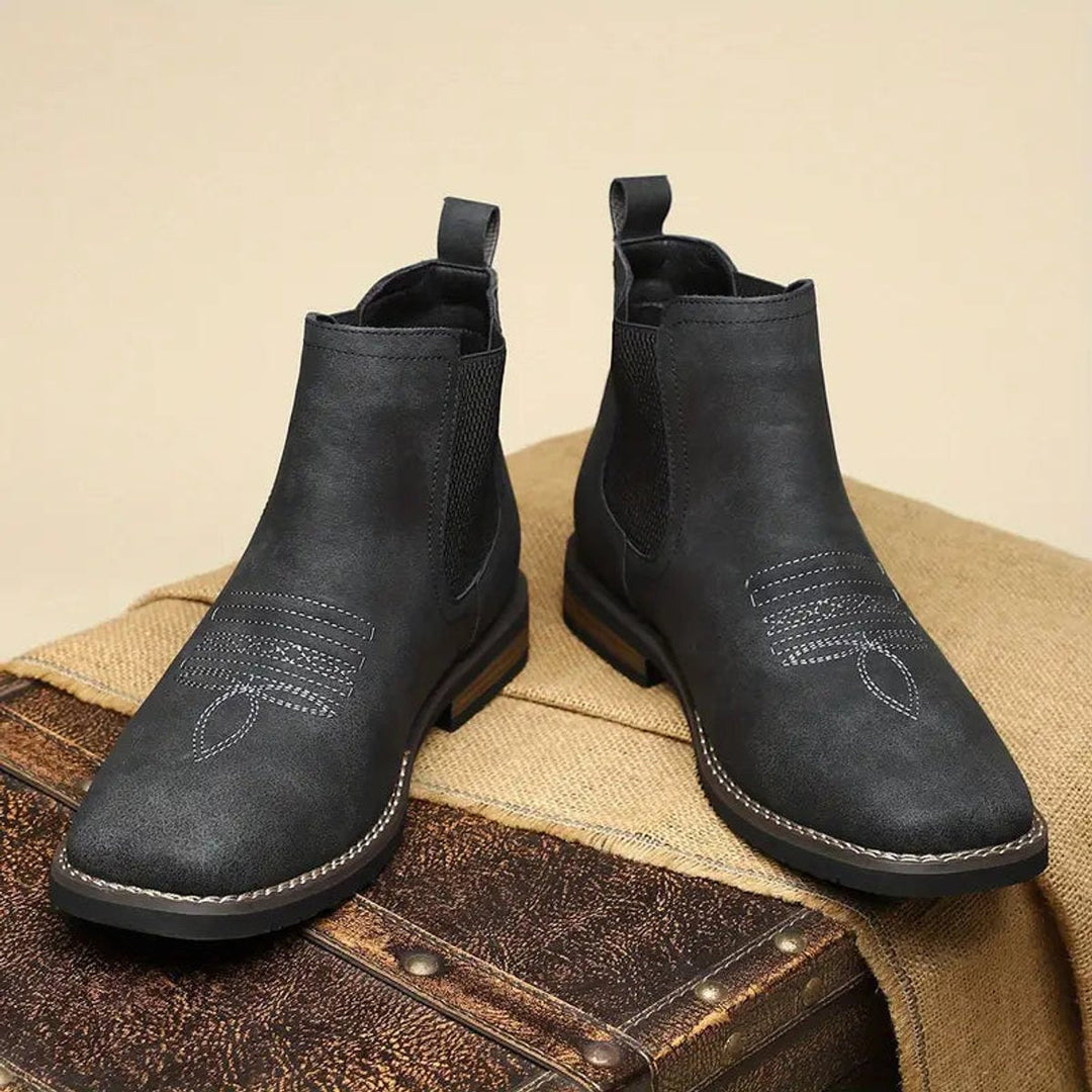 Black leather men's classic slip-on Chelsea boots. Versatile, comfortable, and durable for everyday fashion.