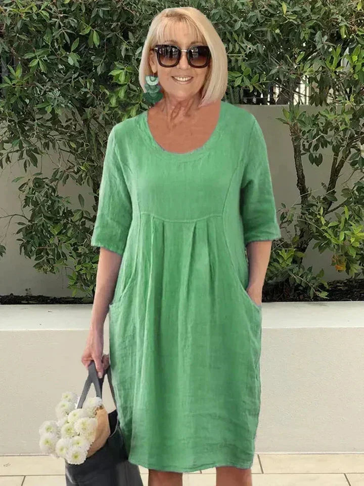 Effortless women's loose midi dress with pockets, combining comfort, style, and everyday versatility.