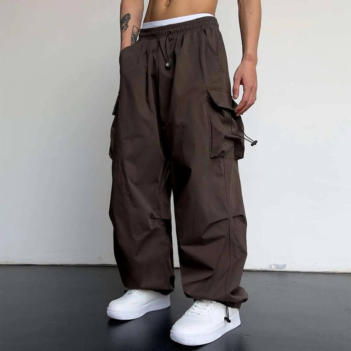Full-length view of black relaxed fit cargo joggers, a blend of comfort, style, and utility.