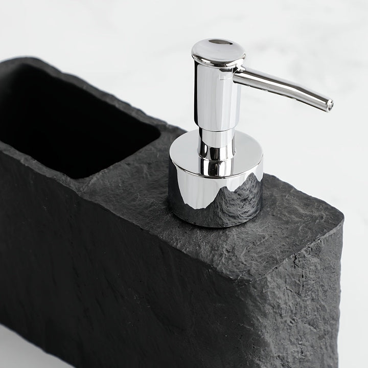 Practical stone-look kitchen accessory: soap dispenser with attached sponge holder.