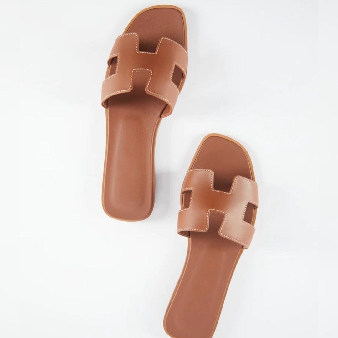 Fashionable women's open-toe slippers, offering elegant comfort for summer home wear.