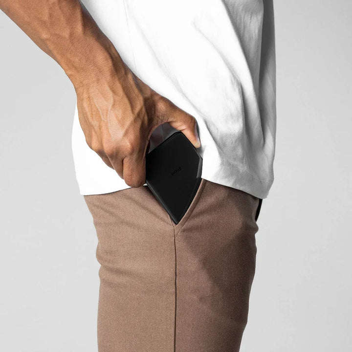 Black versatile chino pants, a staple for any men's fashion wardrobe.
