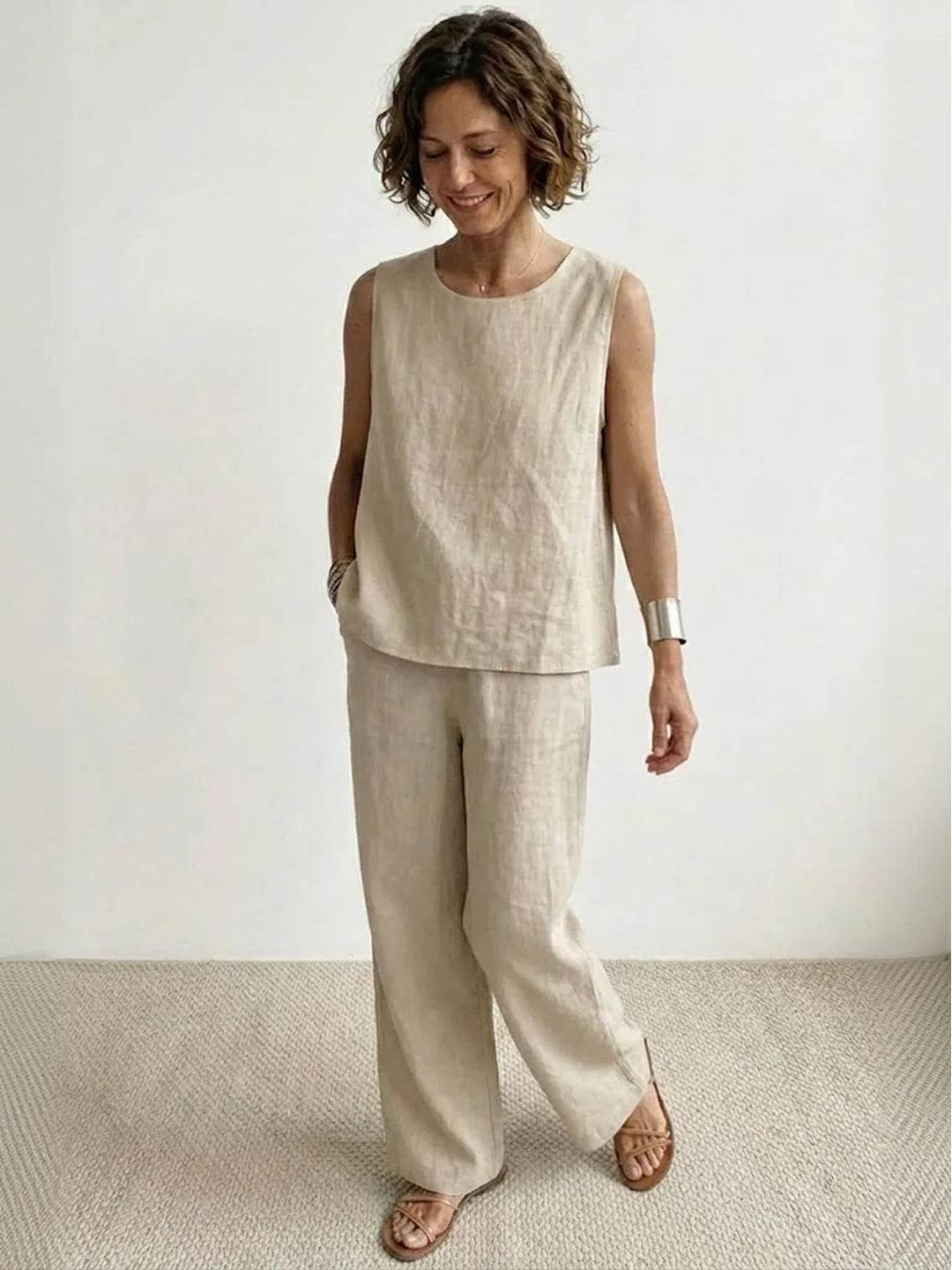 Stylish women's spring fashion: sleeveless tank and wide-leg pants co-ord set, a relaxed fit ensemble.