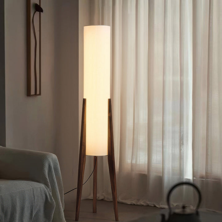 Elegant Scandinavian wood floor lamp with a fabric shade, offering warm ambient light for reading or relaxation.