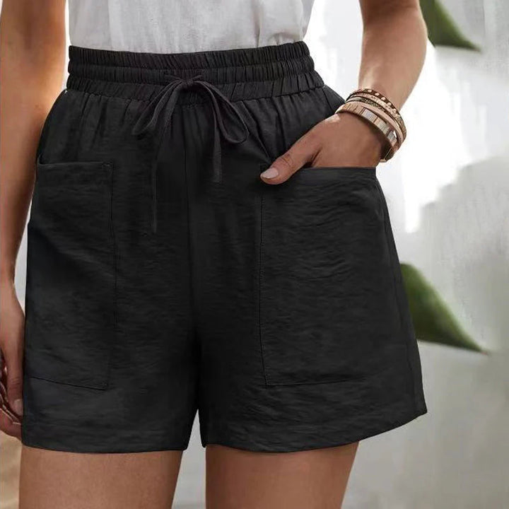 Front view of chic women's summer shorts, highlighting drawstring waist, practical pockets & relaxed fit.