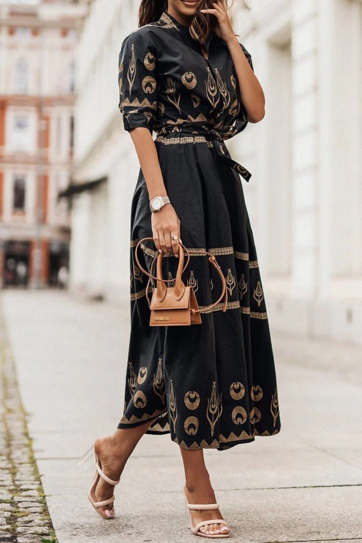 Women's geometric print midi cocktail dress with belt. Flattering three-quarter sleeve & mock neck for elegant style.