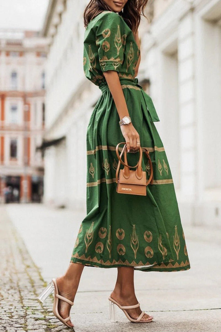Flattering geometric print midi cocktail dress for women. Belted, mock neck, three-quarter sleeve for day-to-night wear.