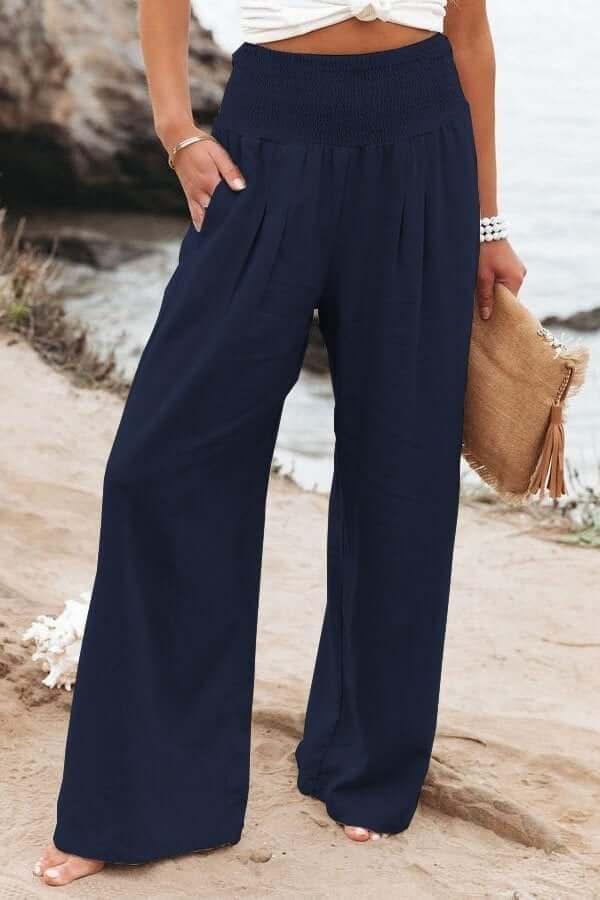 Relaxed fit women's wide-leg pants with smocked waist, offering comfort and a flowing silhouette for summer.